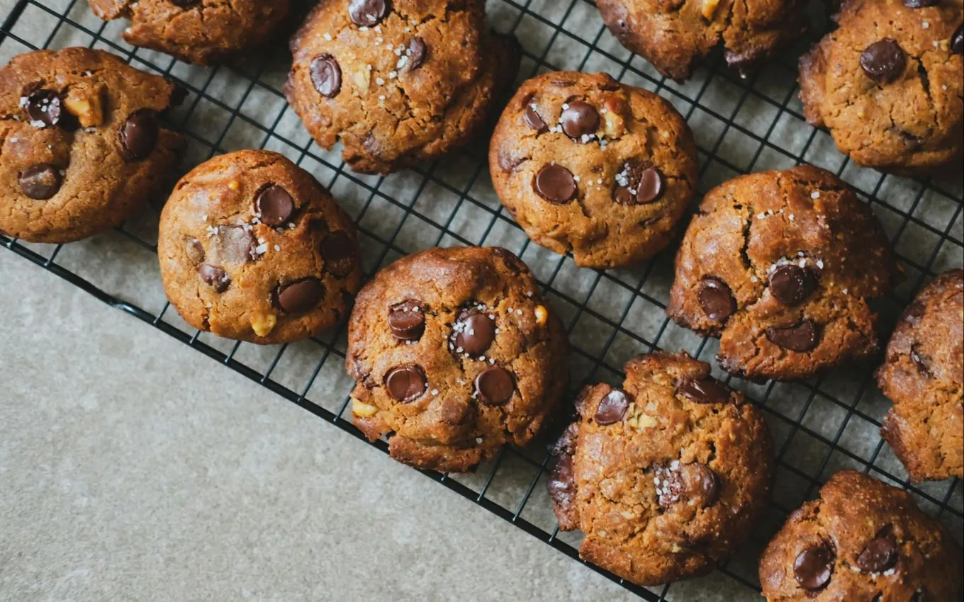 Chocolate chip cookies cooling on a wire rack
