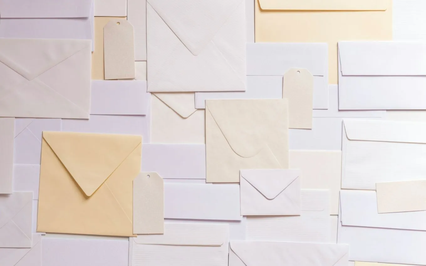 A wall of plain envelopes in white and cream
