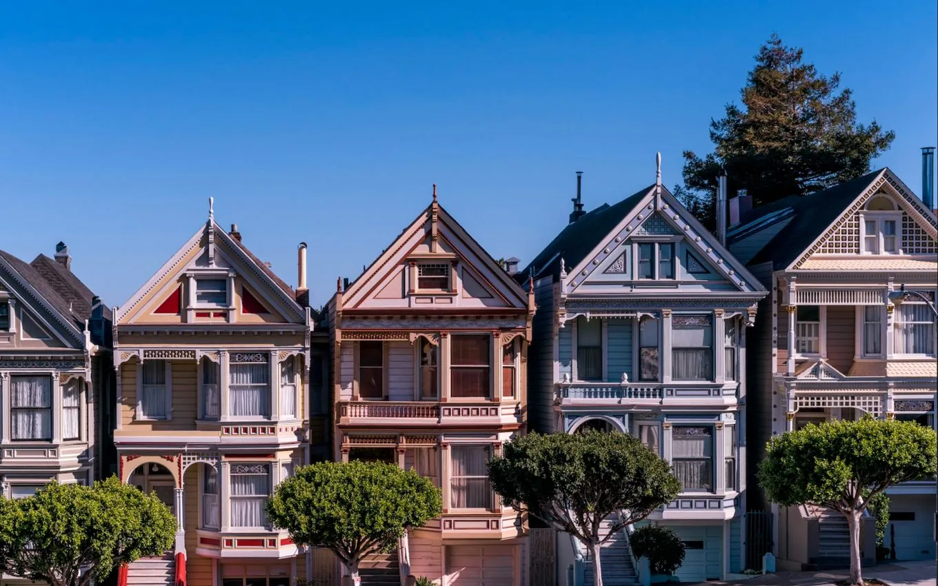 A row of Victorian houses in San Francisco, identical in shape and painted in different colours